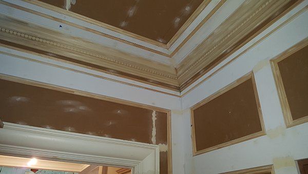 A room with a wooden trim on the ceiling and walls