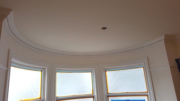 A room with a lot of windows and a curved ceiling