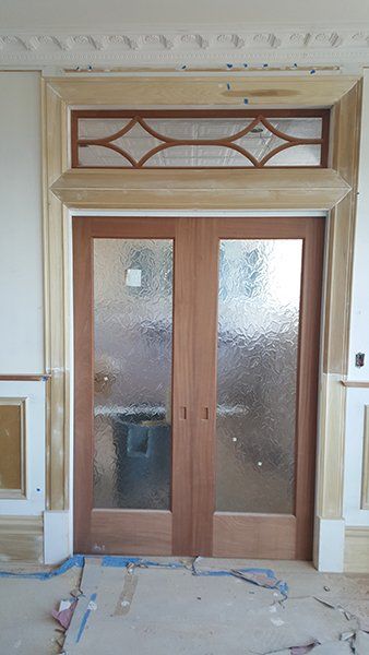 A pair of wooden sliding glass doors 