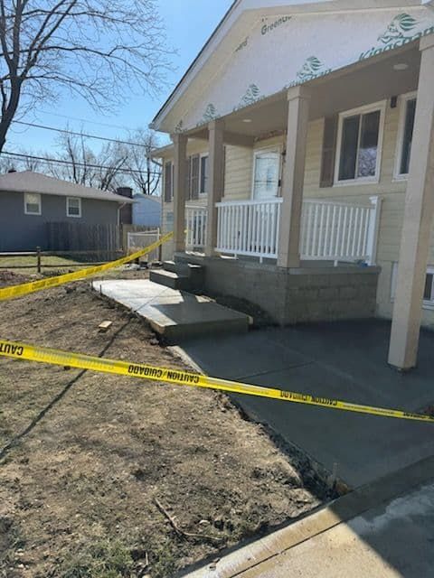 New construction house with concrete steps and caution tape.