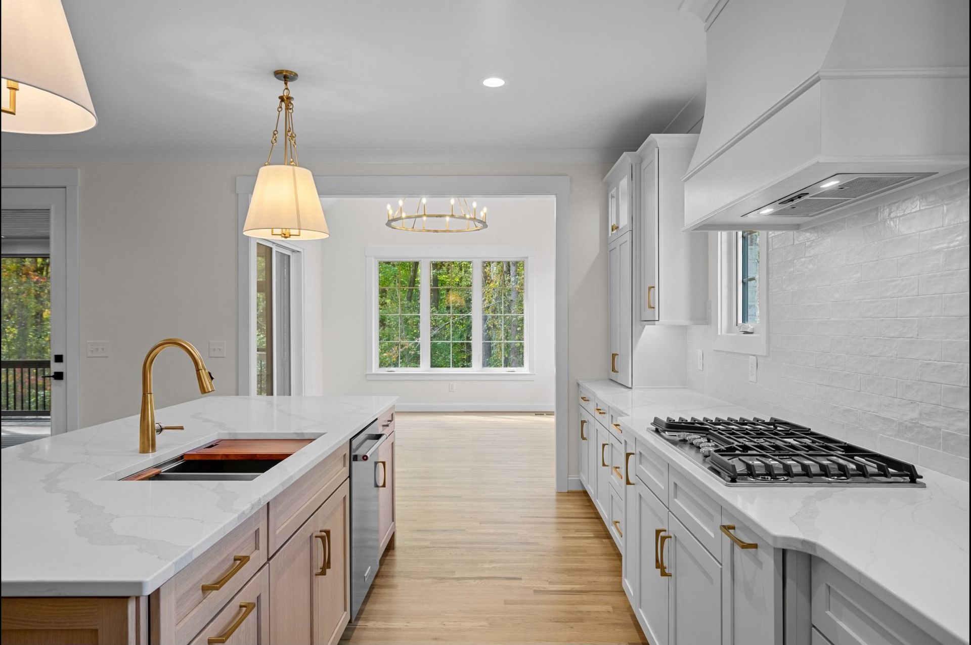 A kitchen with white cabinets and a stove-top oven
