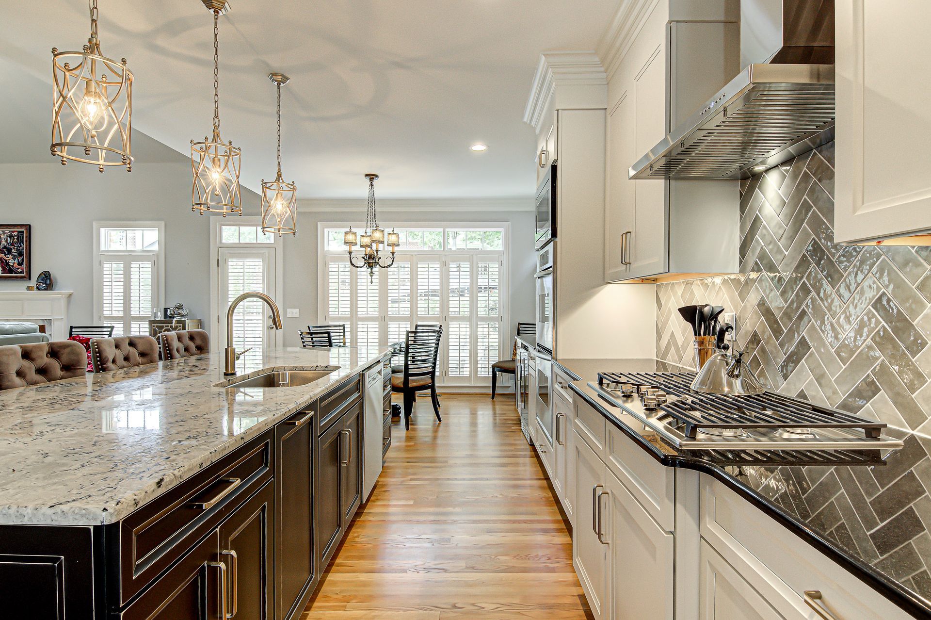 A kitchen with stainless steel appliances and granite counter tops.