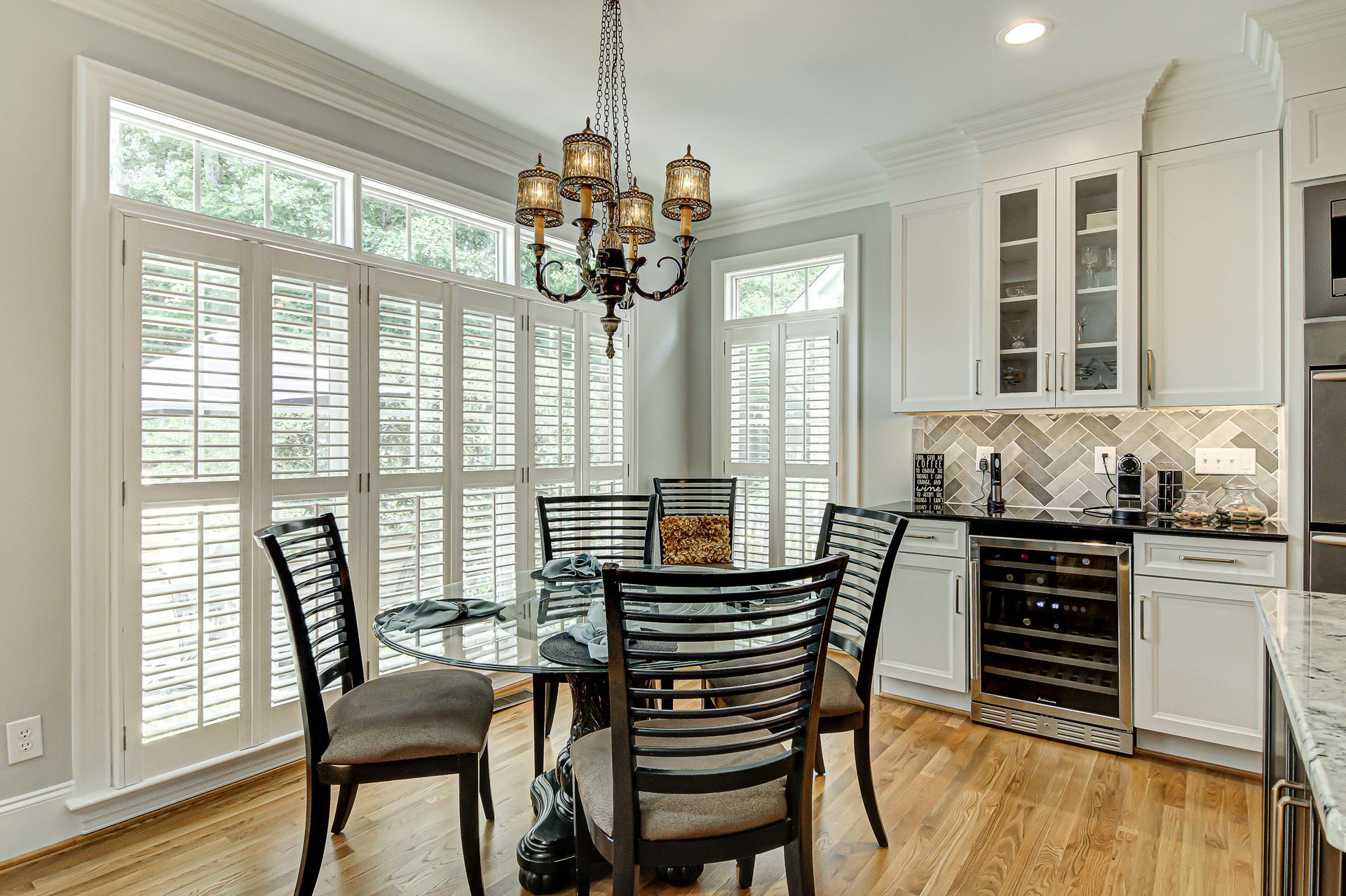 A dining room with a table and chairs and a chandelier.
