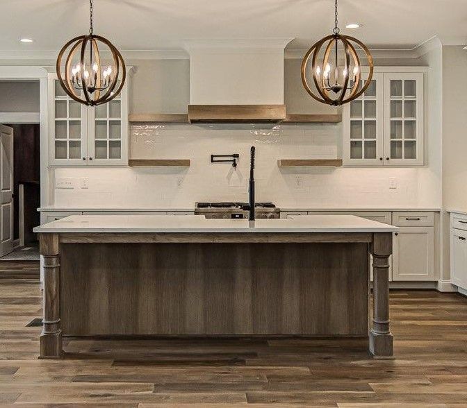 There is a large island in the middle of the kitchen.