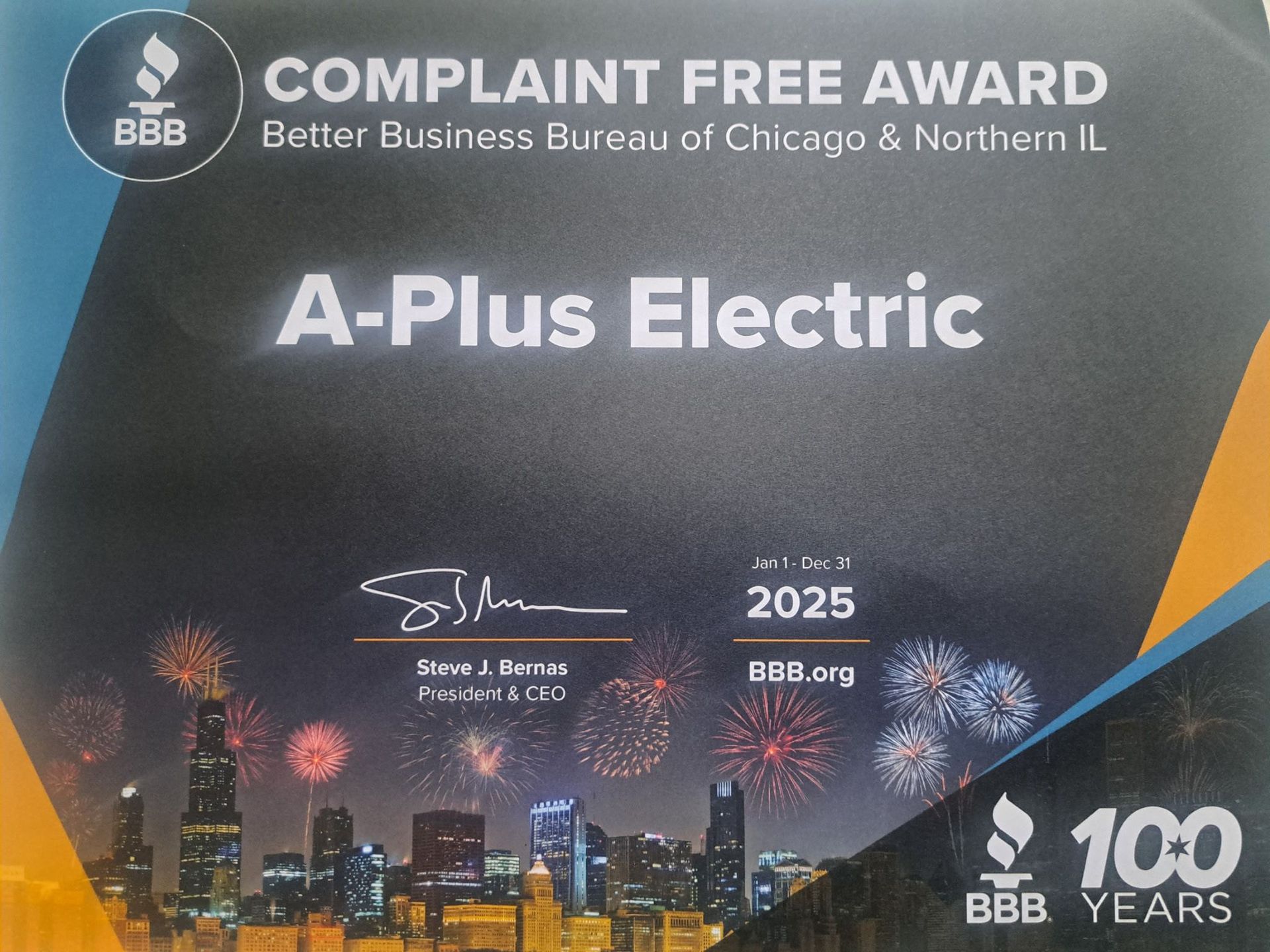 A 2025 Better Business Bureau Complaint Free Award certificate for A-Plus Electric, featuring a Chicago skyline background.