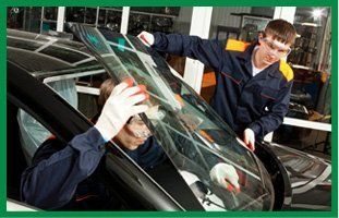 Repairmen installing new windshield