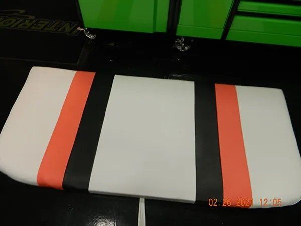 White with orange and black boat cushion seating