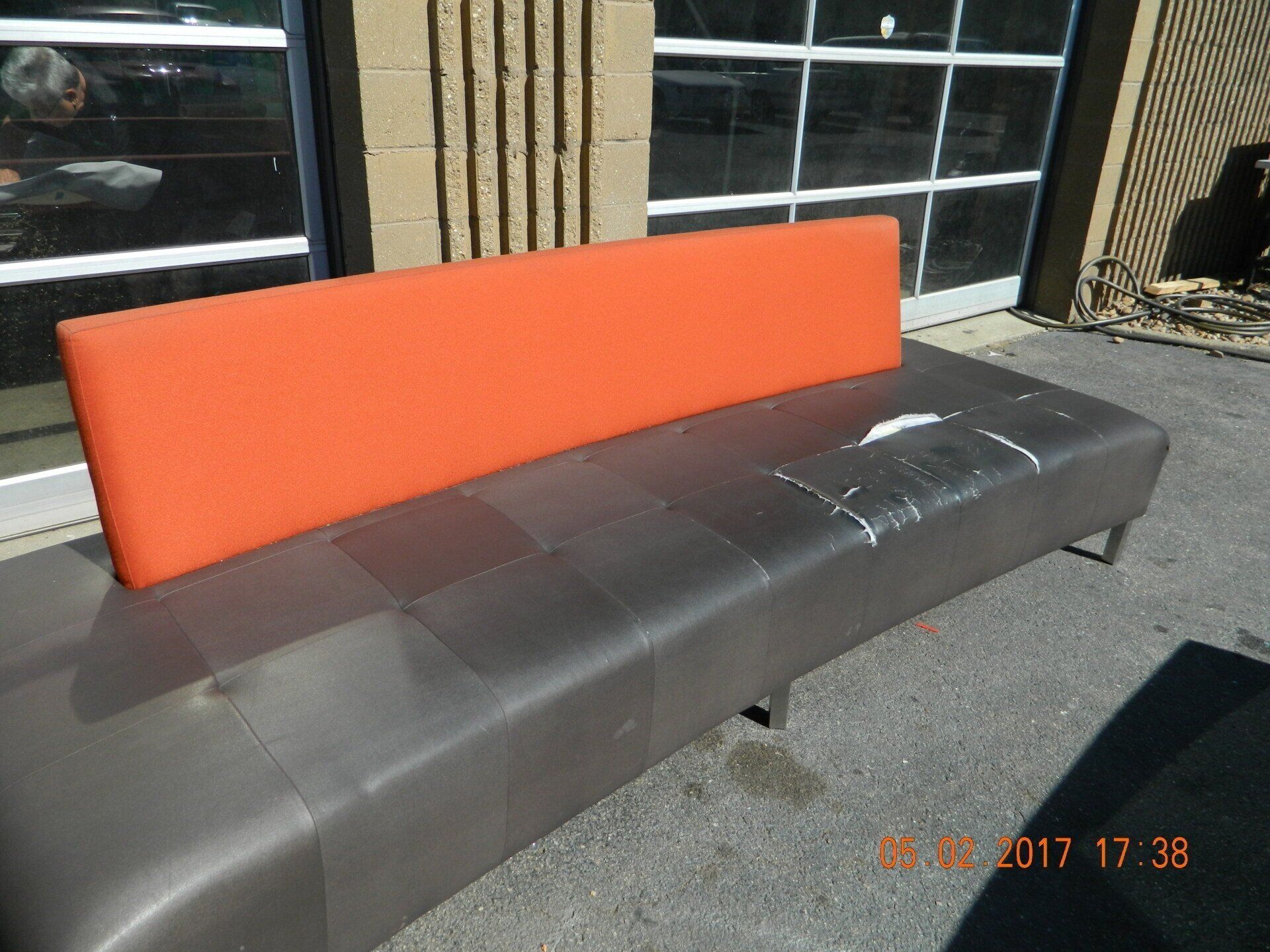 Custom black and orange colored sofa before repair