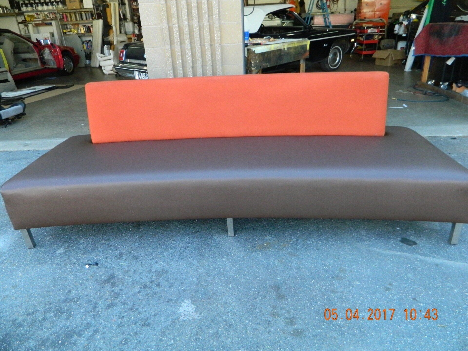 Custom black and orange colored sofa after repair