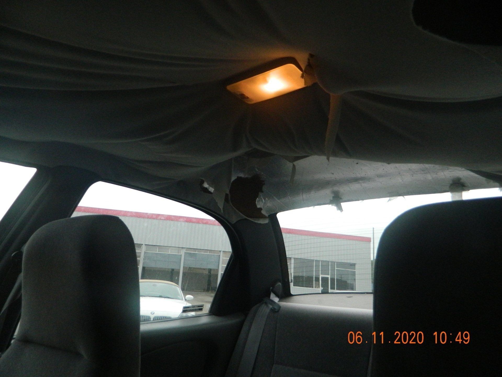 Gray headliner extreme damage with dome light