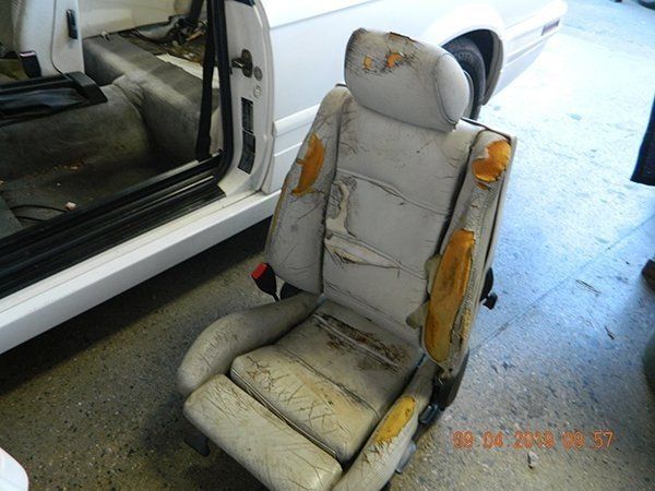 Damaged light gray driver seat