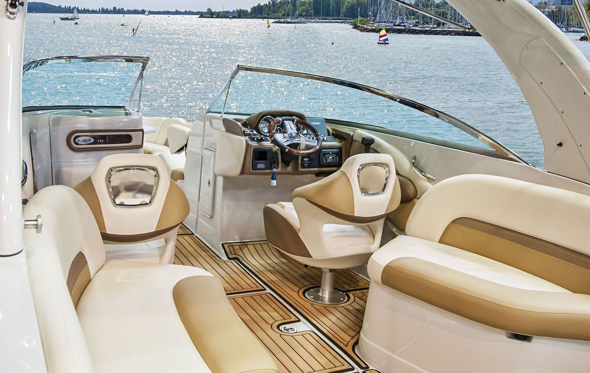A man is driving a boat at sunset.