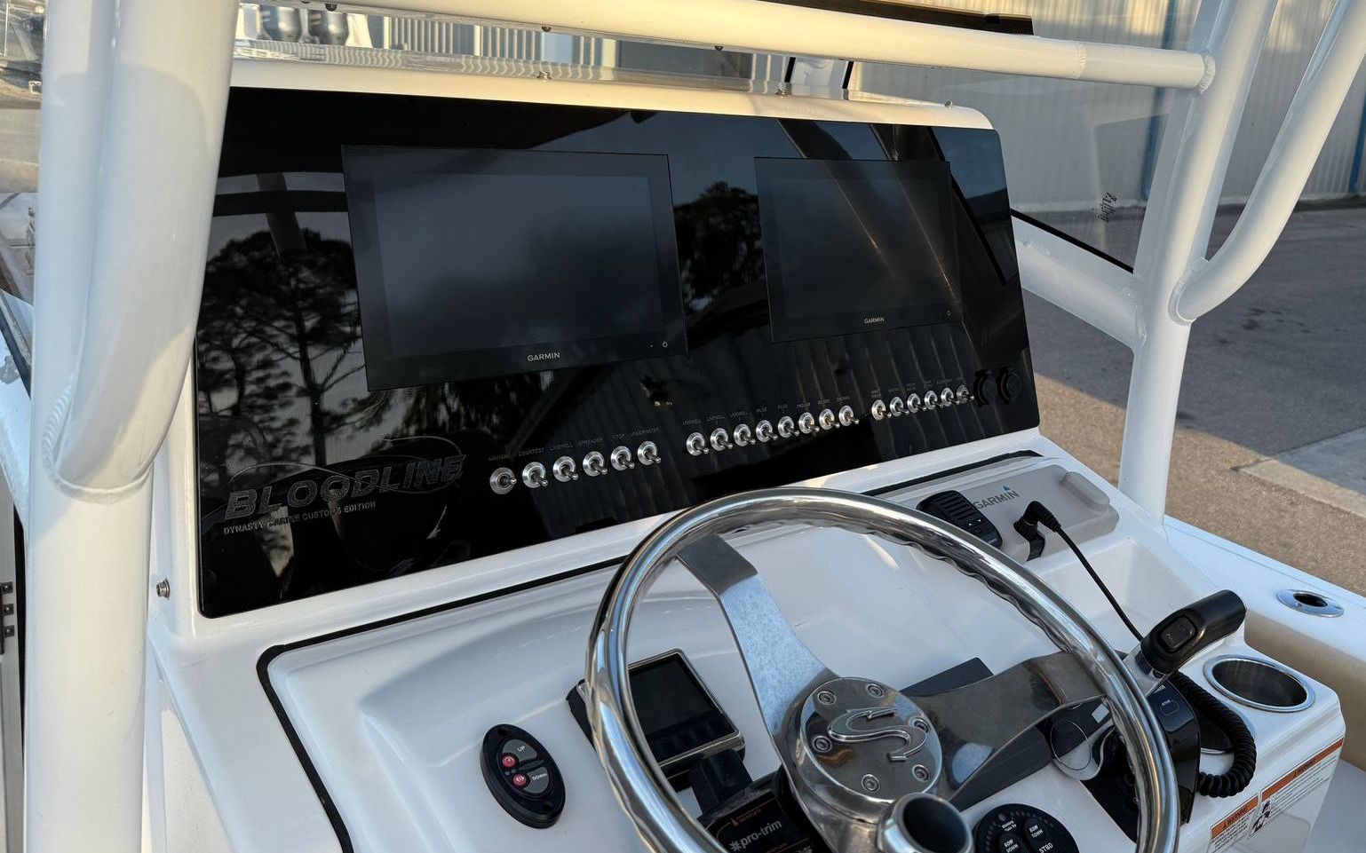 A man is driving a boat at sunset.