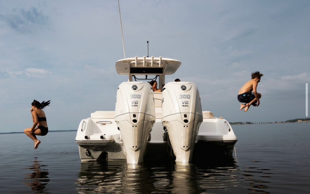 A white boat is floating on top of a body of water.