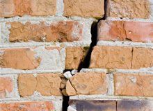 A brick wall with a crack caused by an earthquake