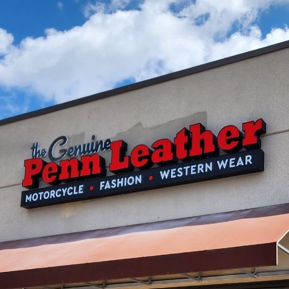 A sign for the genuine penn leather motorcycle fashion and western wear
