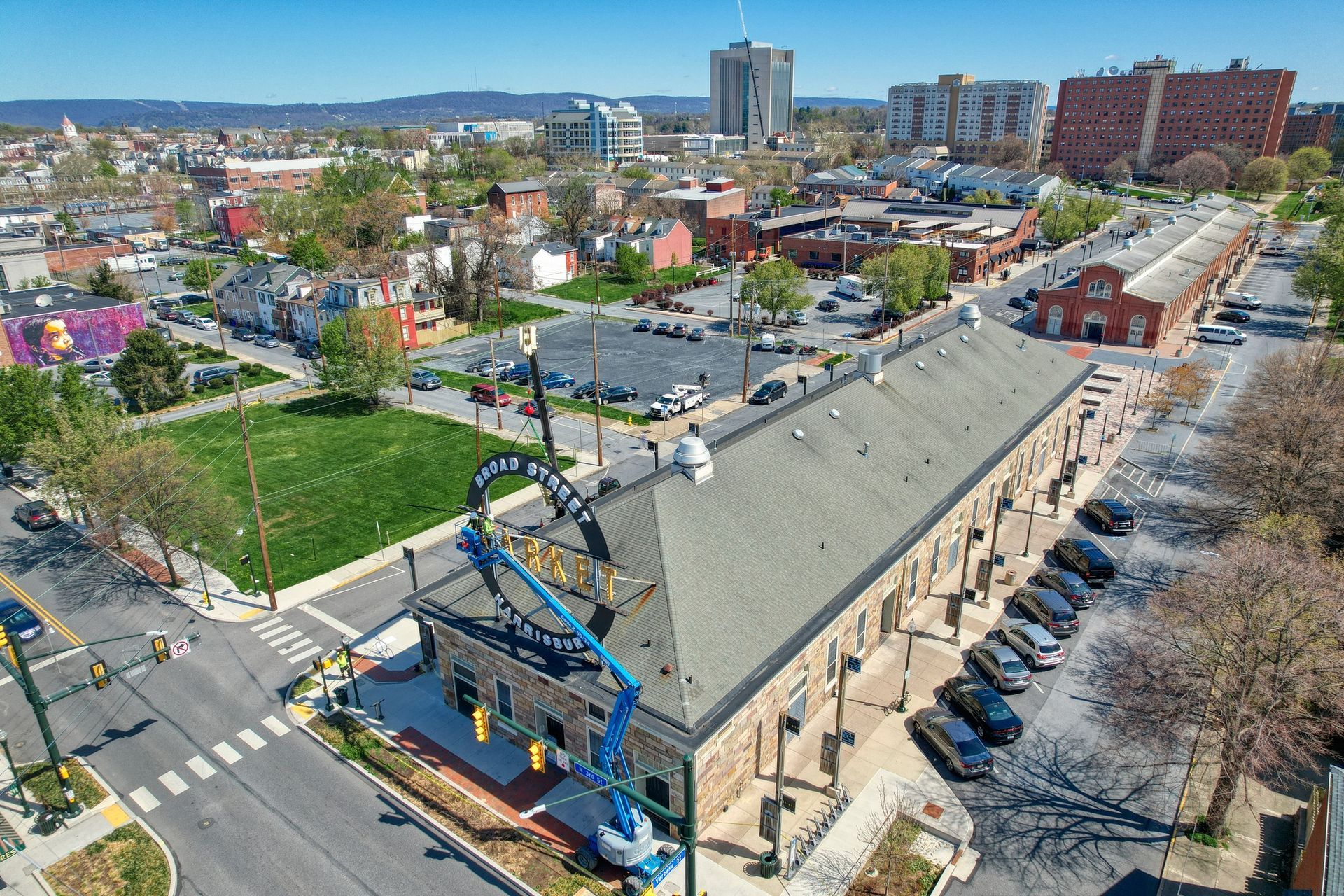 An aerial view of a city with a large building in the middle