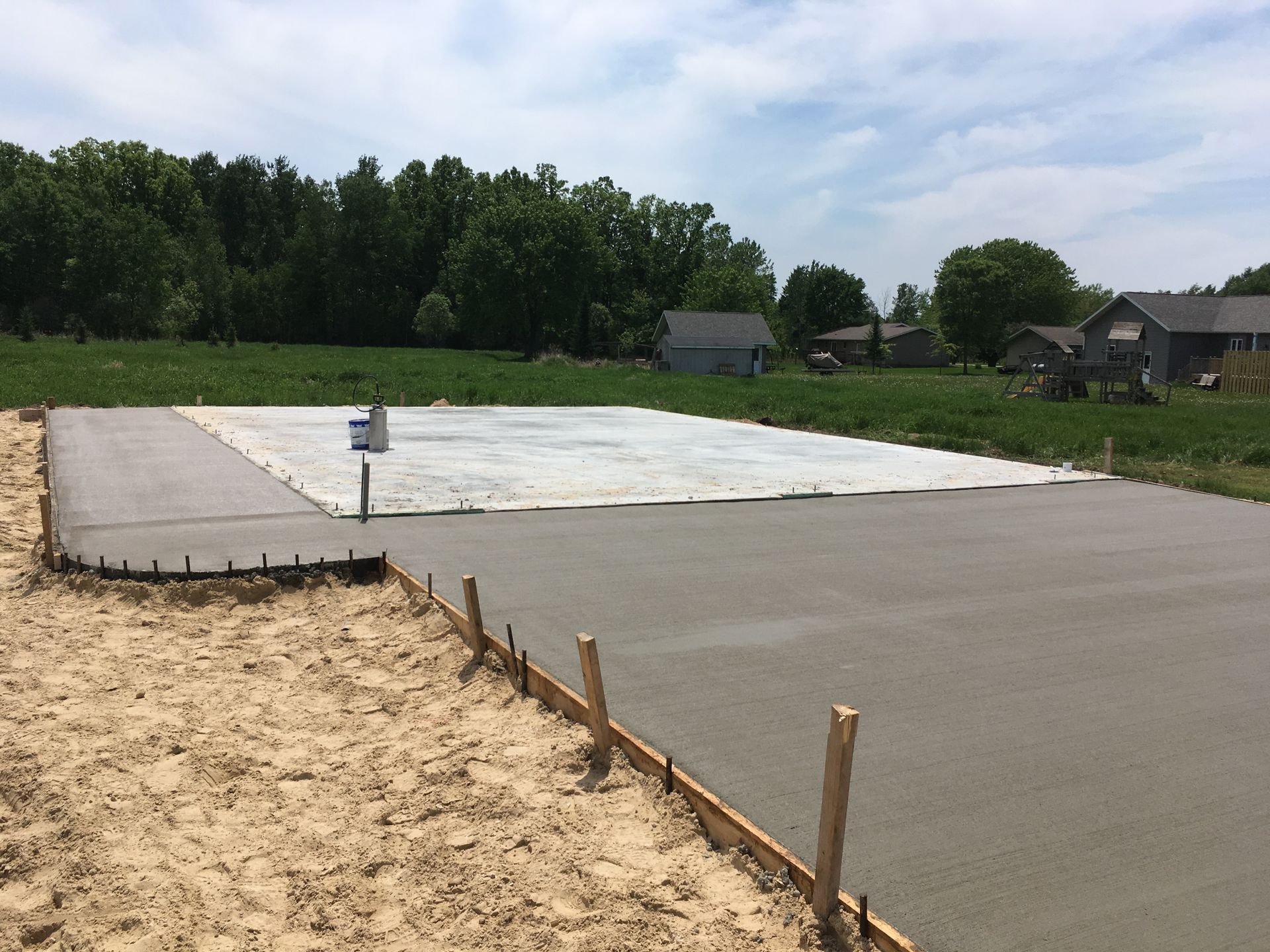 A basketball court is being built in the middle of a field
