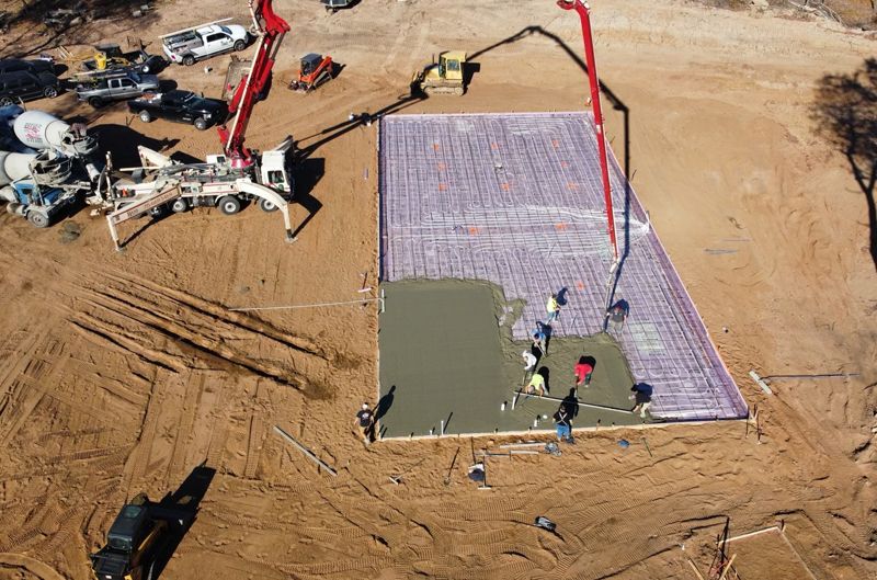 An aerial view of a construction site with a concrete pump.