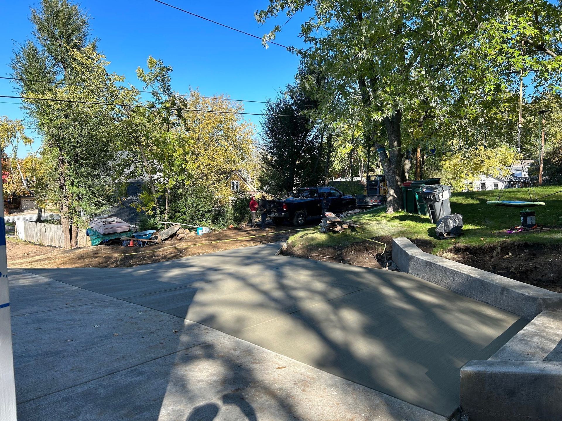 A concrete walkway is being built on the side of a road.