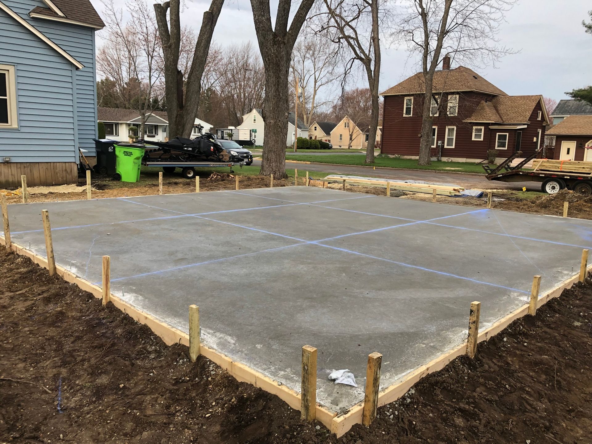 A concrete slab is being built in front of a house.
