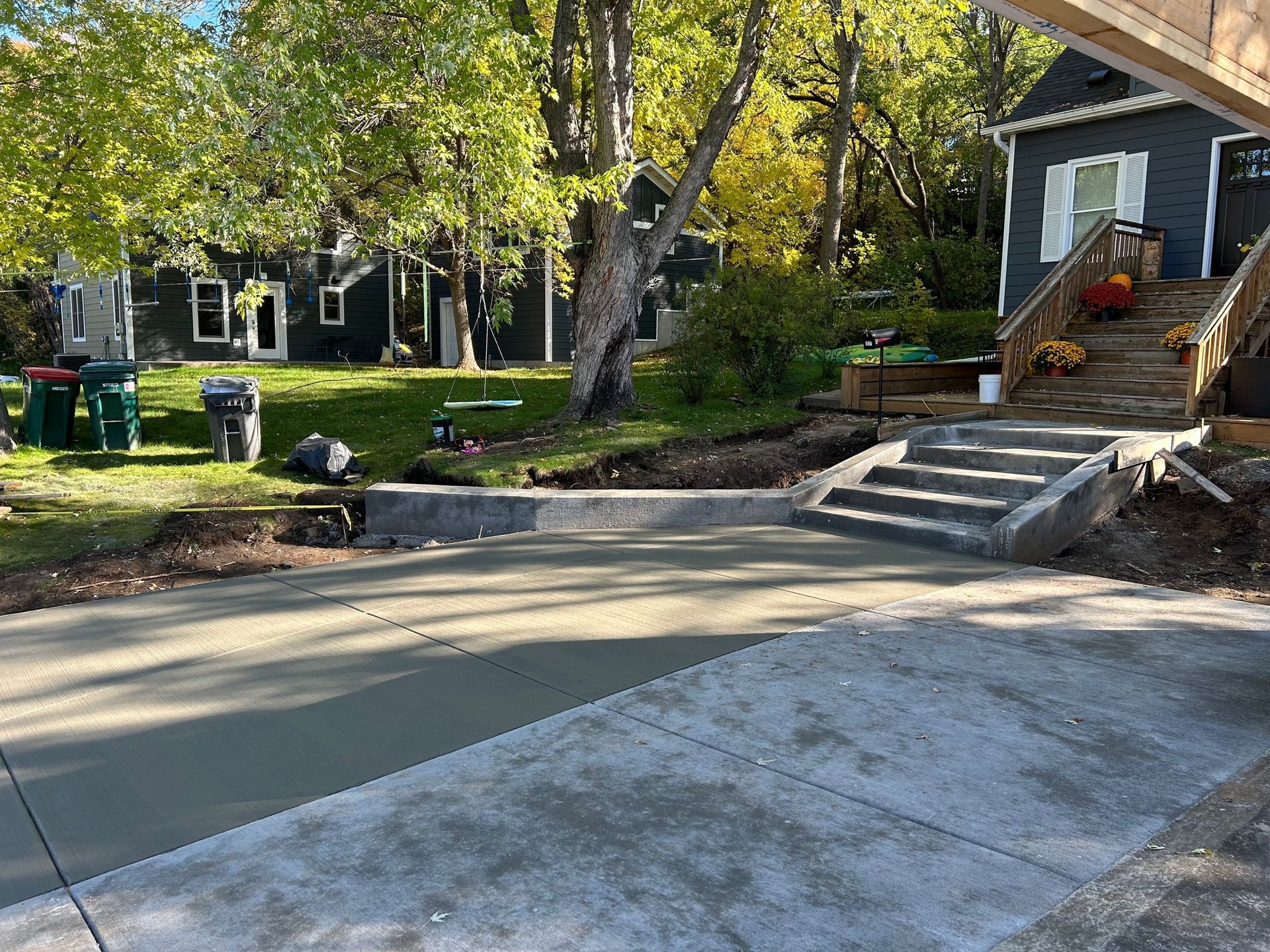A concrete driveway is being built in front of a house.