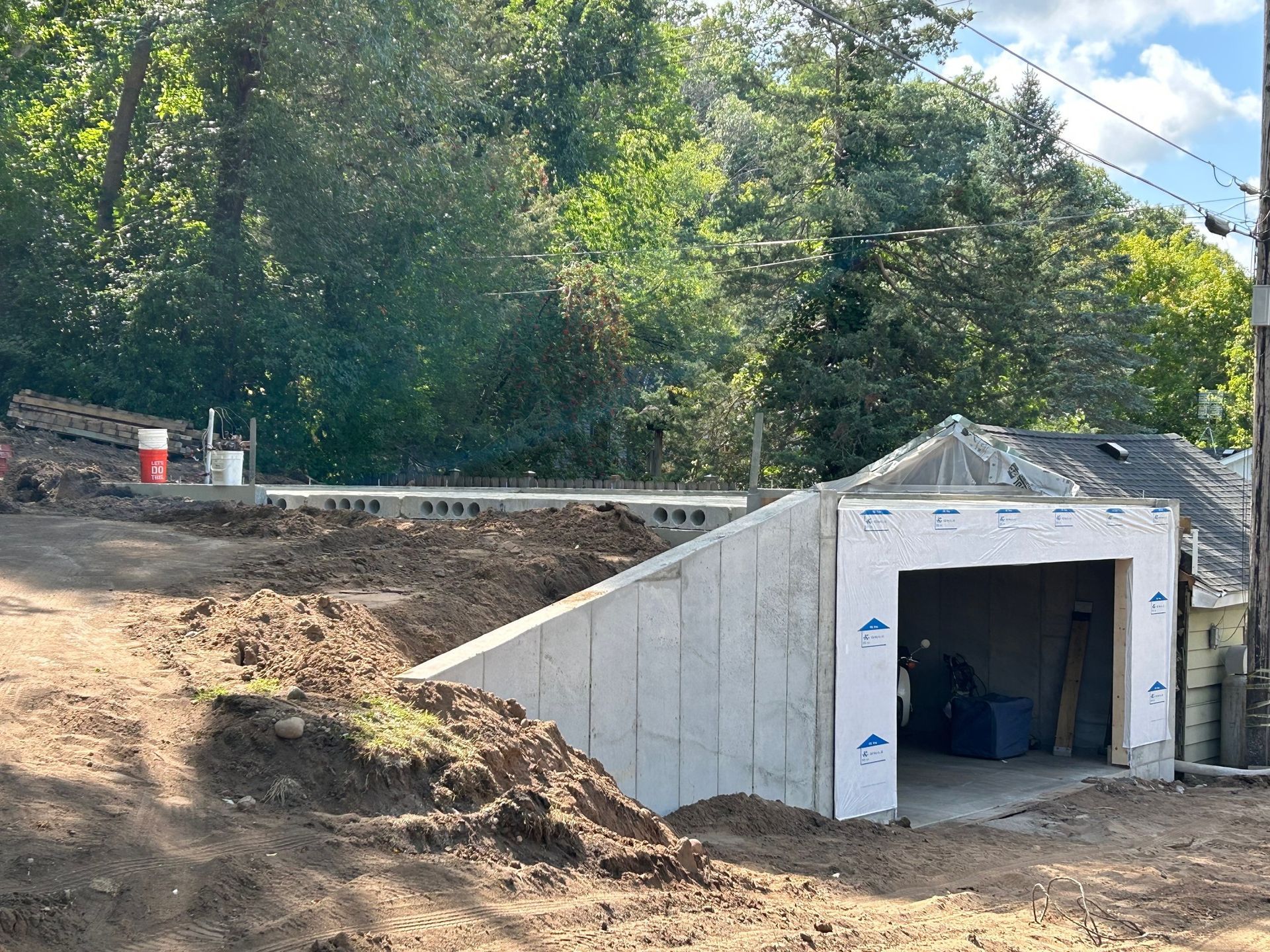 A concrete garage is being built in the middle of a dirt field.