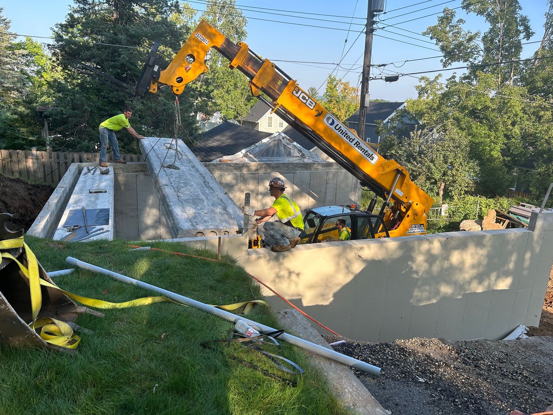 A crane is being used to lift a large piece of concrete.