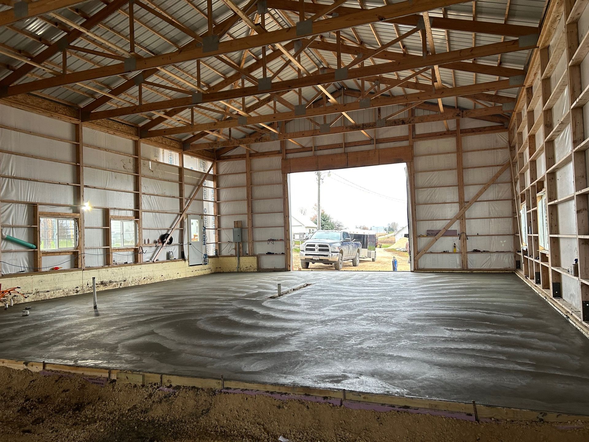 The inside of a building under construction with a concrete floor.