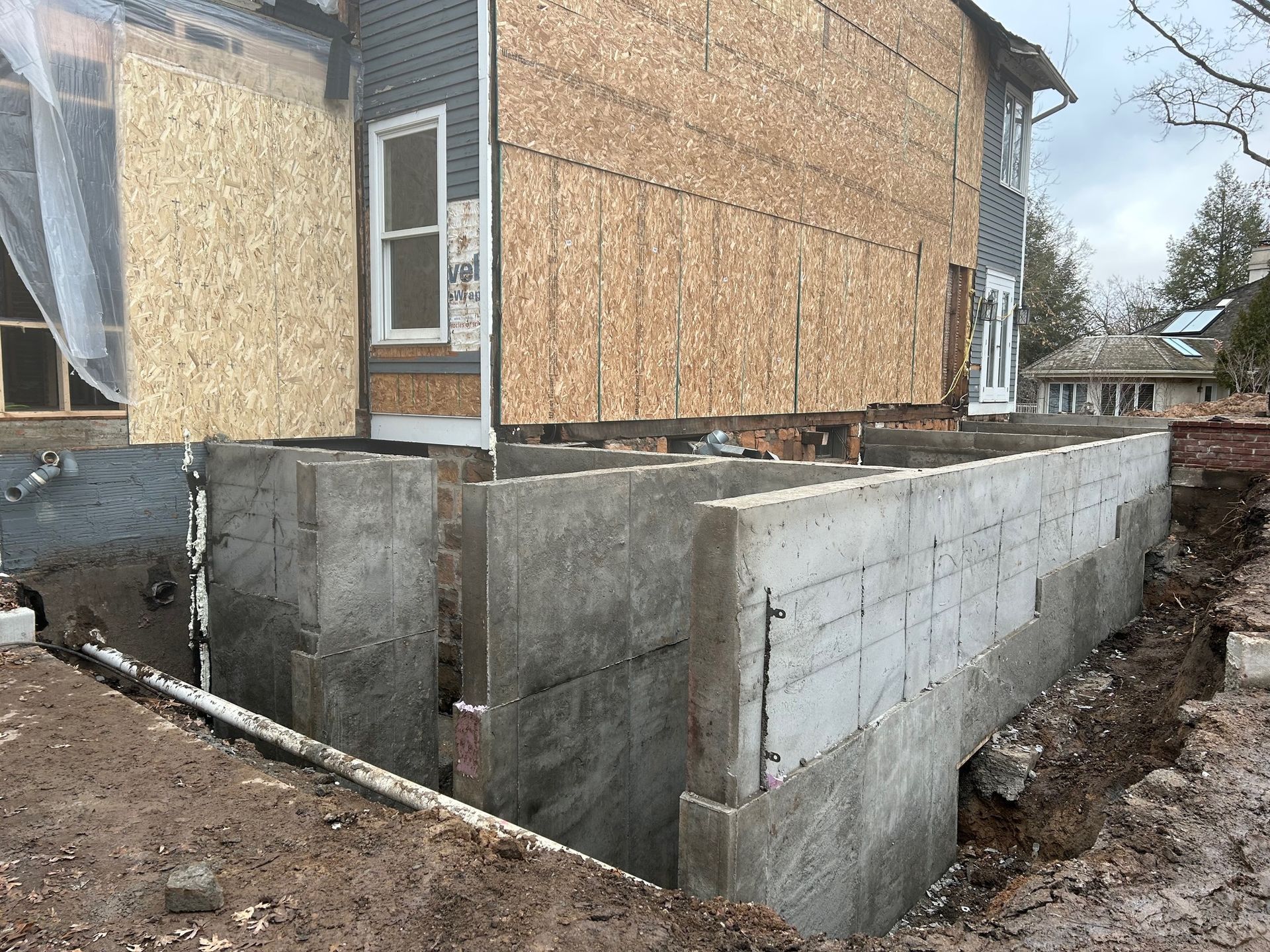 A house is being built with a concrete foundation.