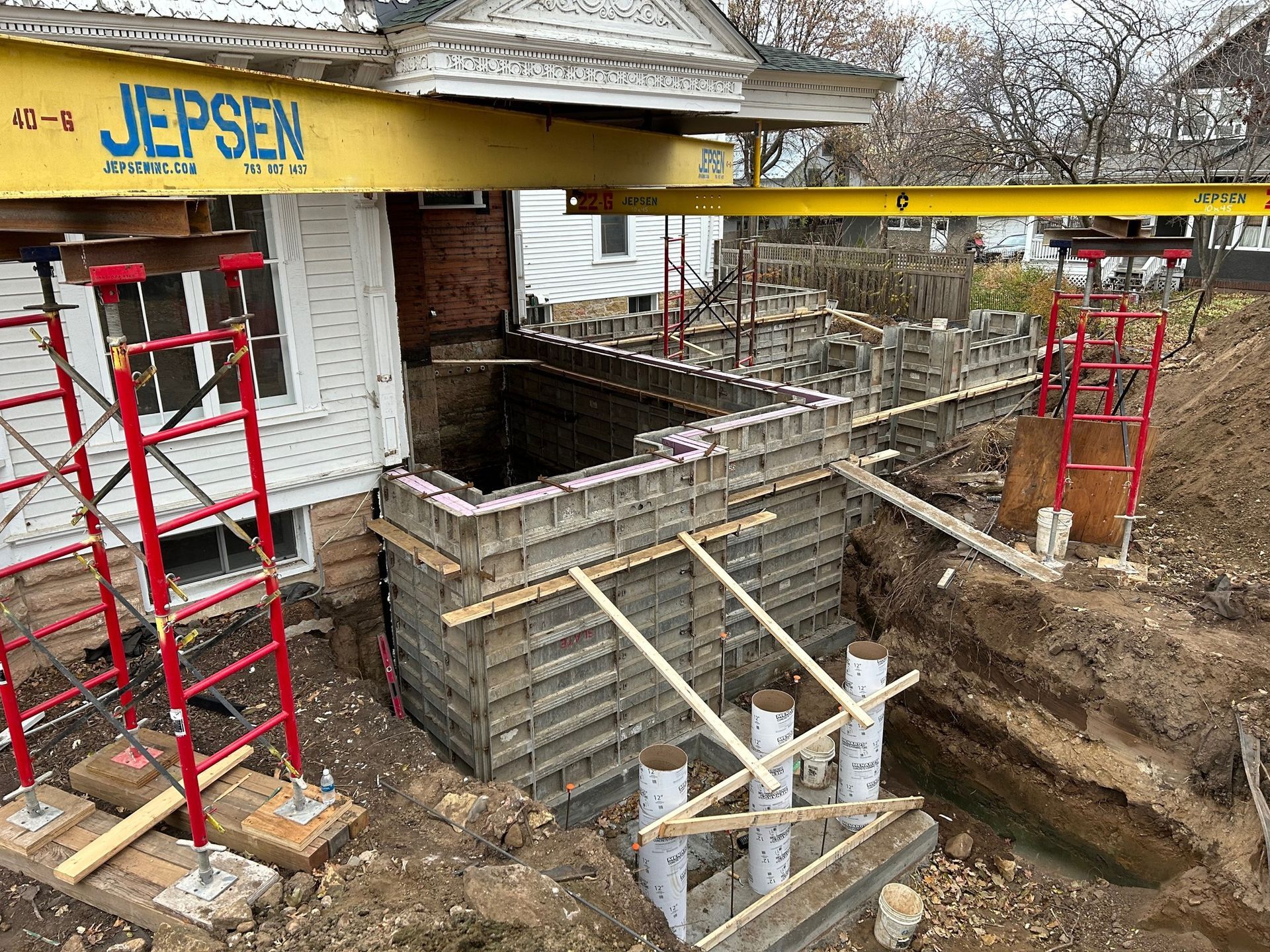 A house is being built on top of a dirt field.