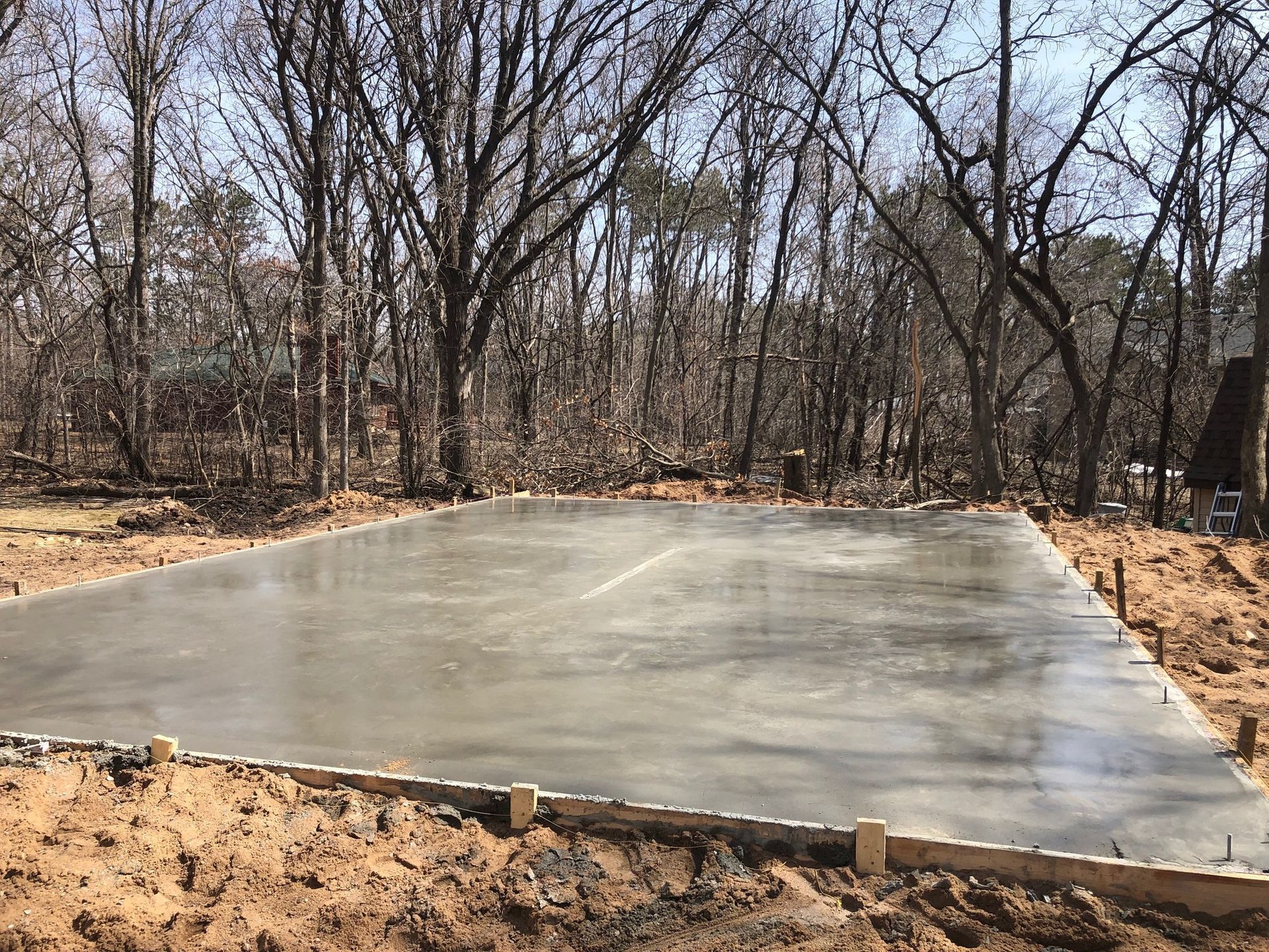 A concrete floor is being built in the middle of a forest.