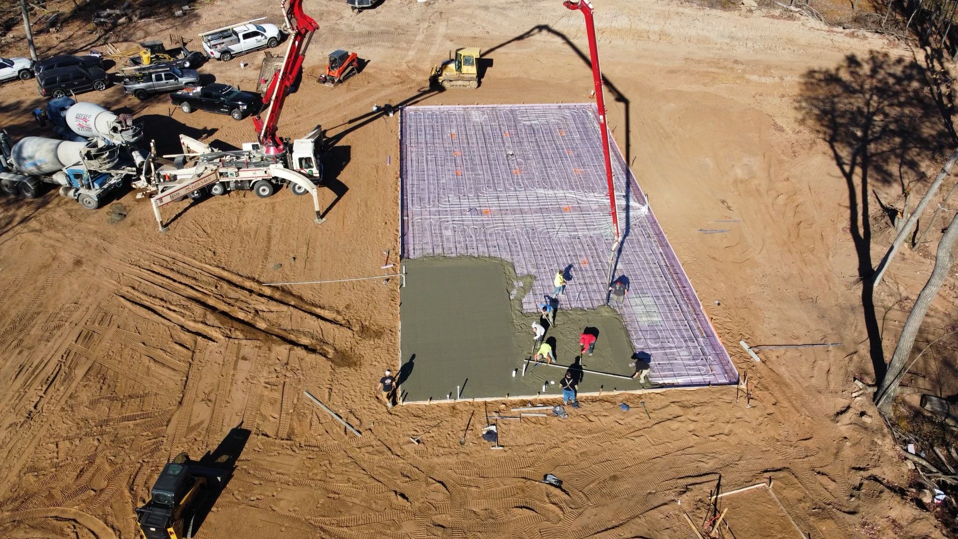 An aerial view of a construction site with a concrete pump.