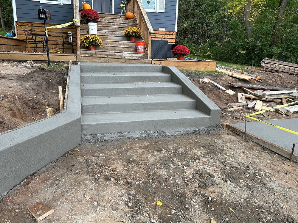 A concrete staircase is being built in front of a house.
