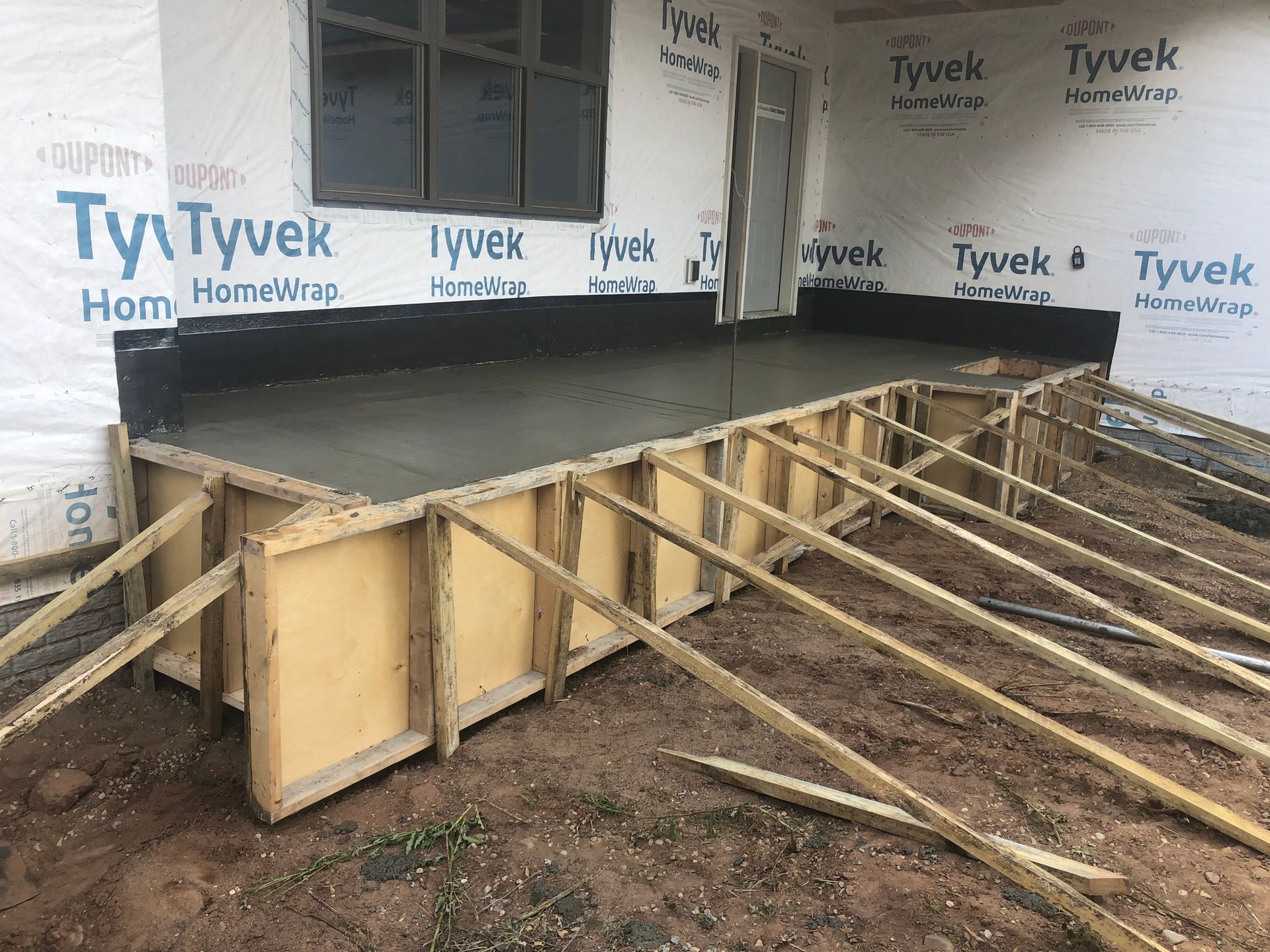 A concrete platform is being built in front of a building.