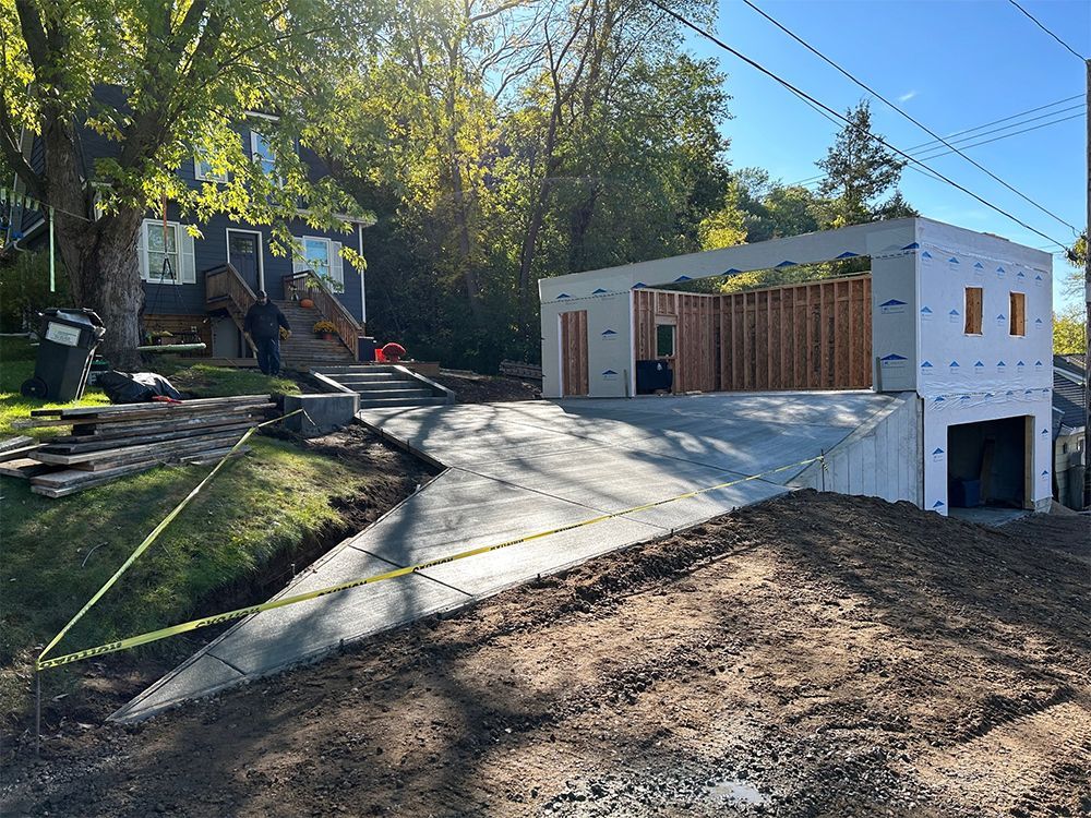 A garage is being built in the backyard of a house.