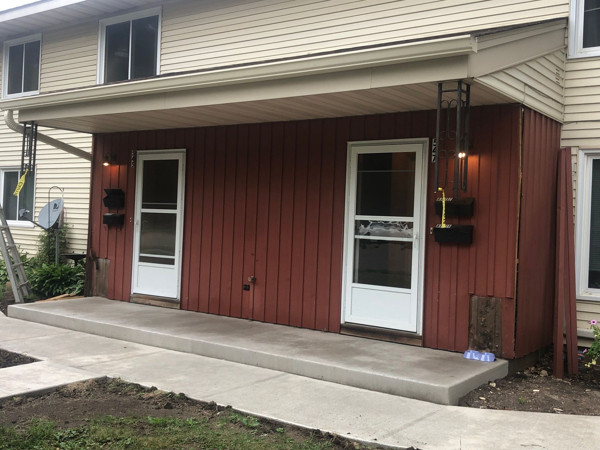A red house with white doors and a porch