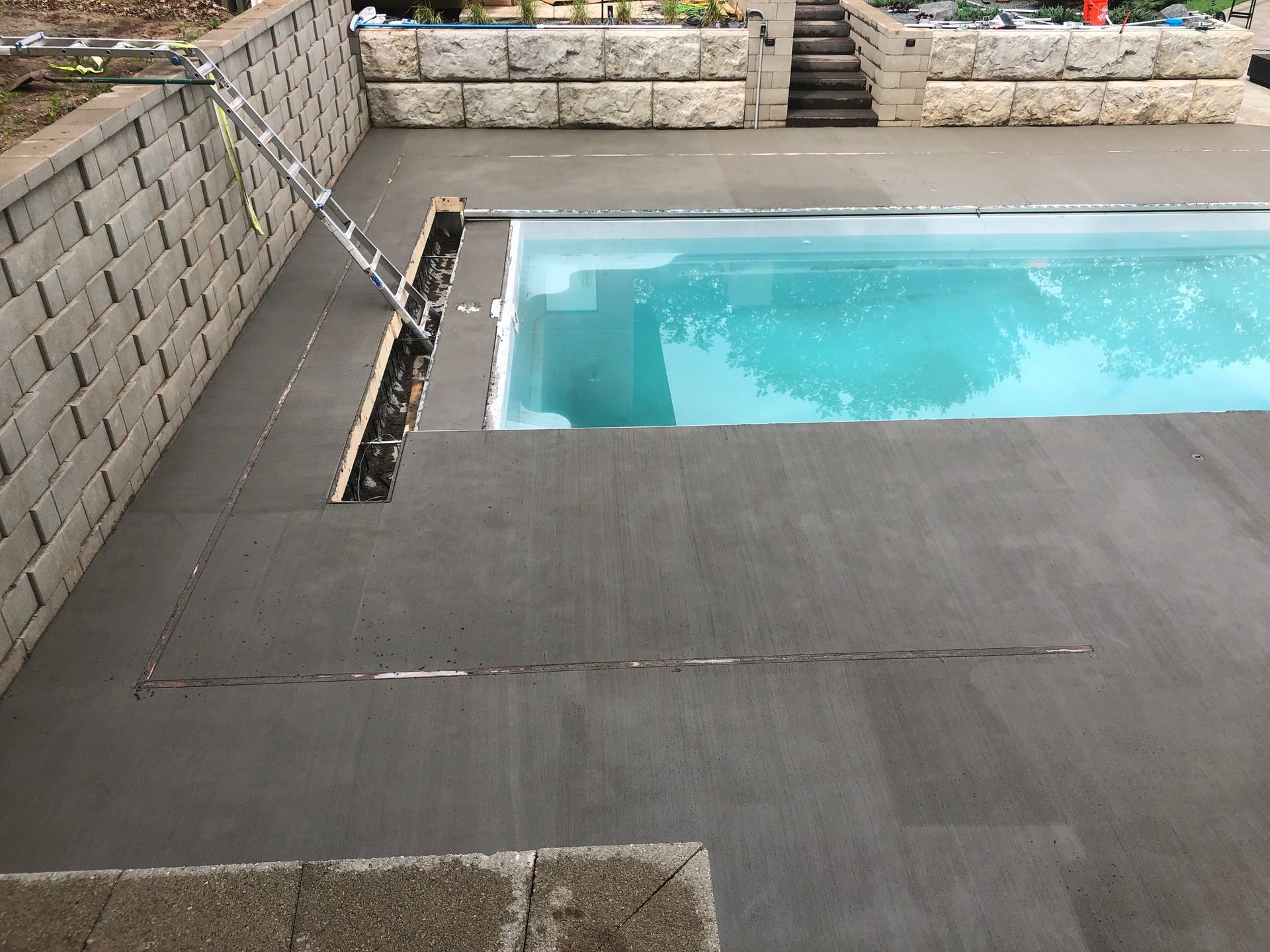 A large swimming pool with stairs leading to it