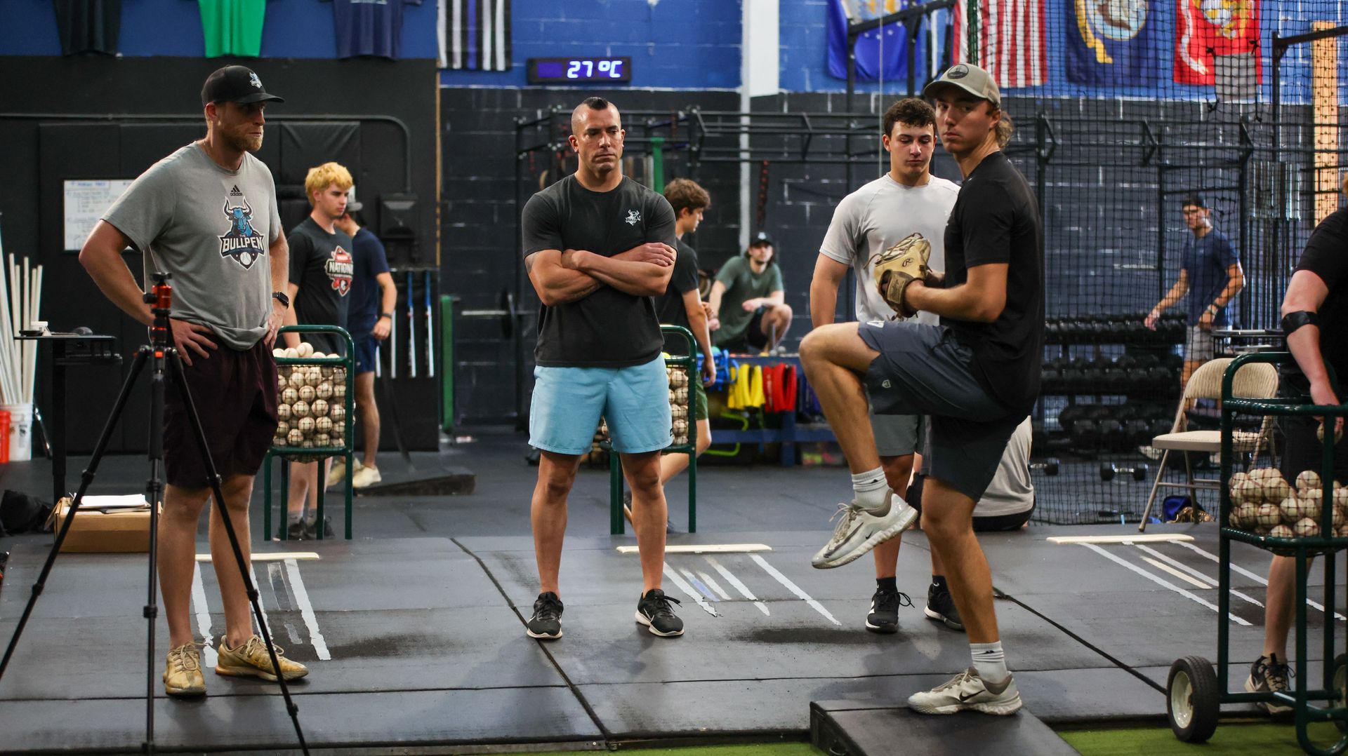 A baseball player is swinging his bat at a pitch.