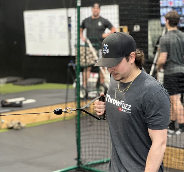 A baseball player wearing a helmet and glove is ready to catch a ball