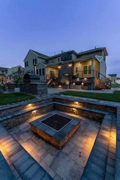 There is a fire pit in the backyard of a house.