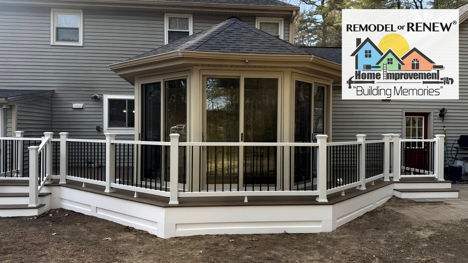 A home addition with a sunroom and deck, featuring gray siding, white railings, and a logo for Remodel to Renew.