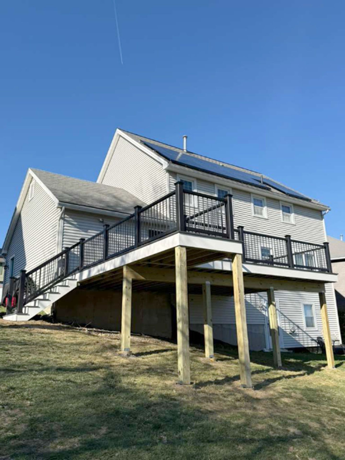 A house with a large elevated wooden deck