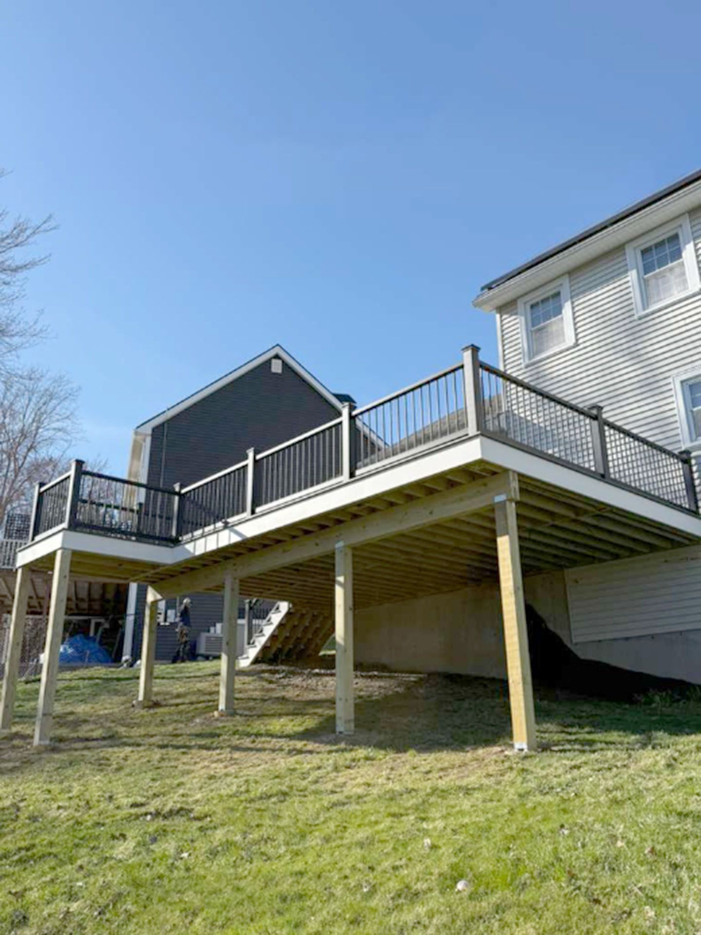A large, elevated wooden deck with dark railings