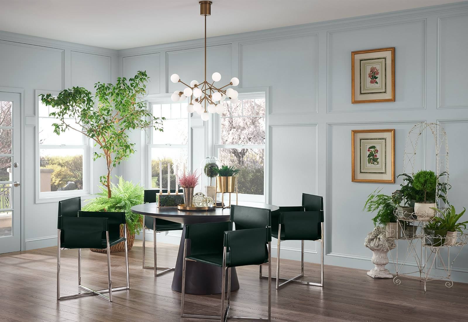 A dining room with a table and chairs and a chandelier.