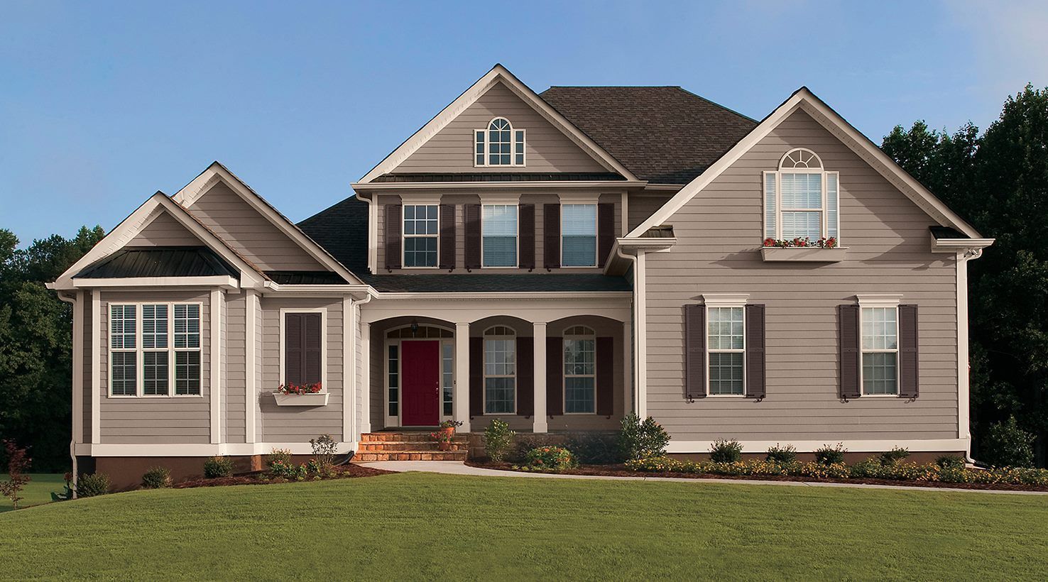 A large house with a lot of windows and shutters