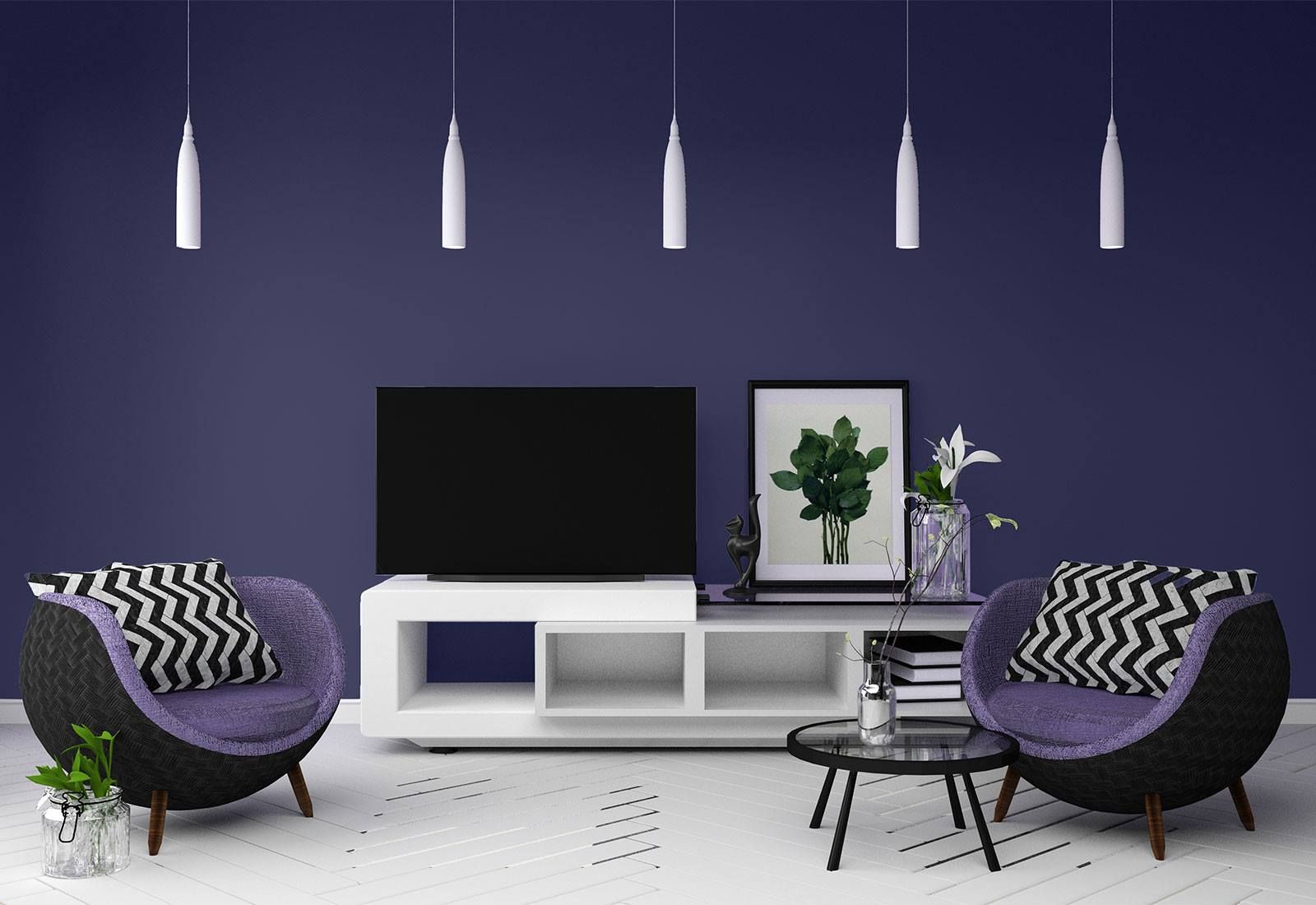 A living room with two chairs , a table , a television and a purple wall.