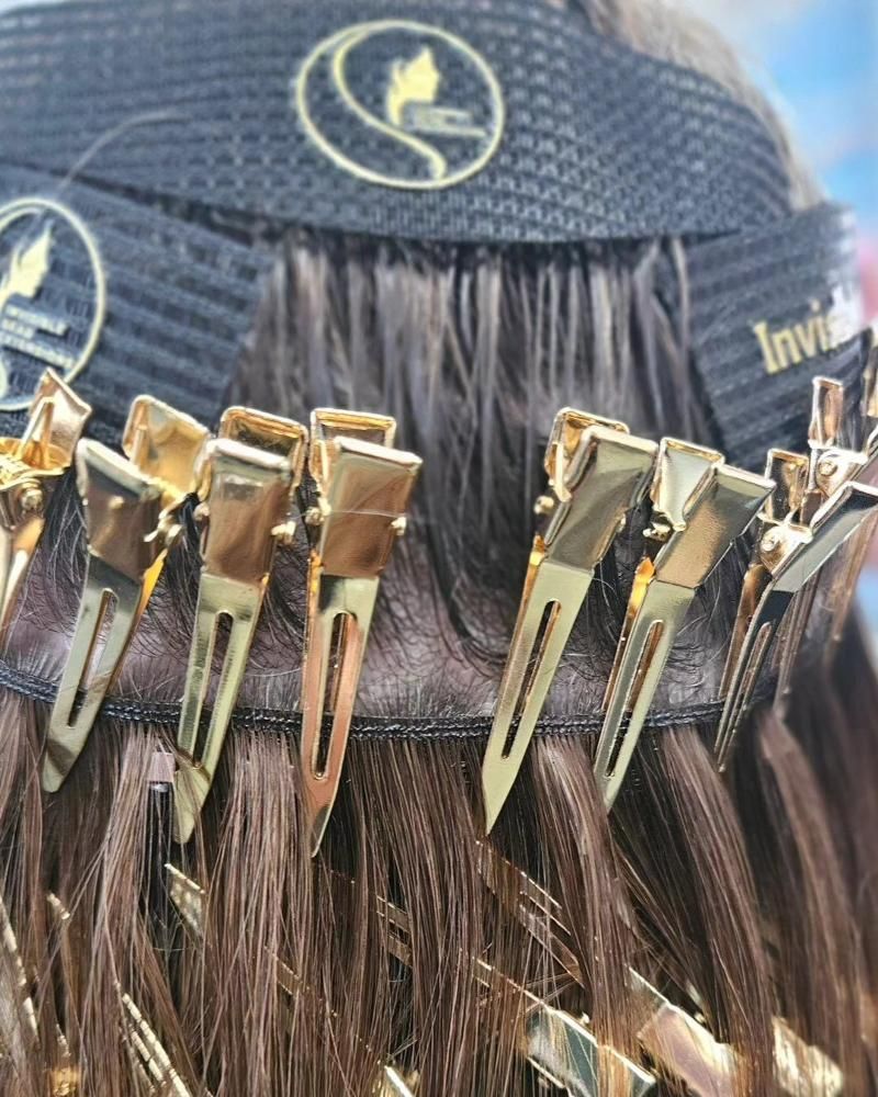 A close up of a person 's hair with clips on it.