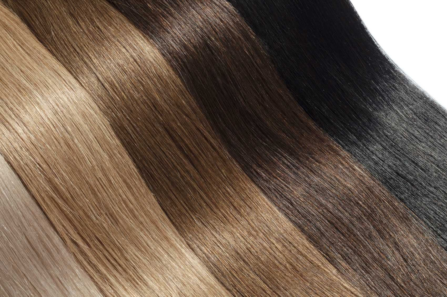 A close up of three bundles of hair in different colors.