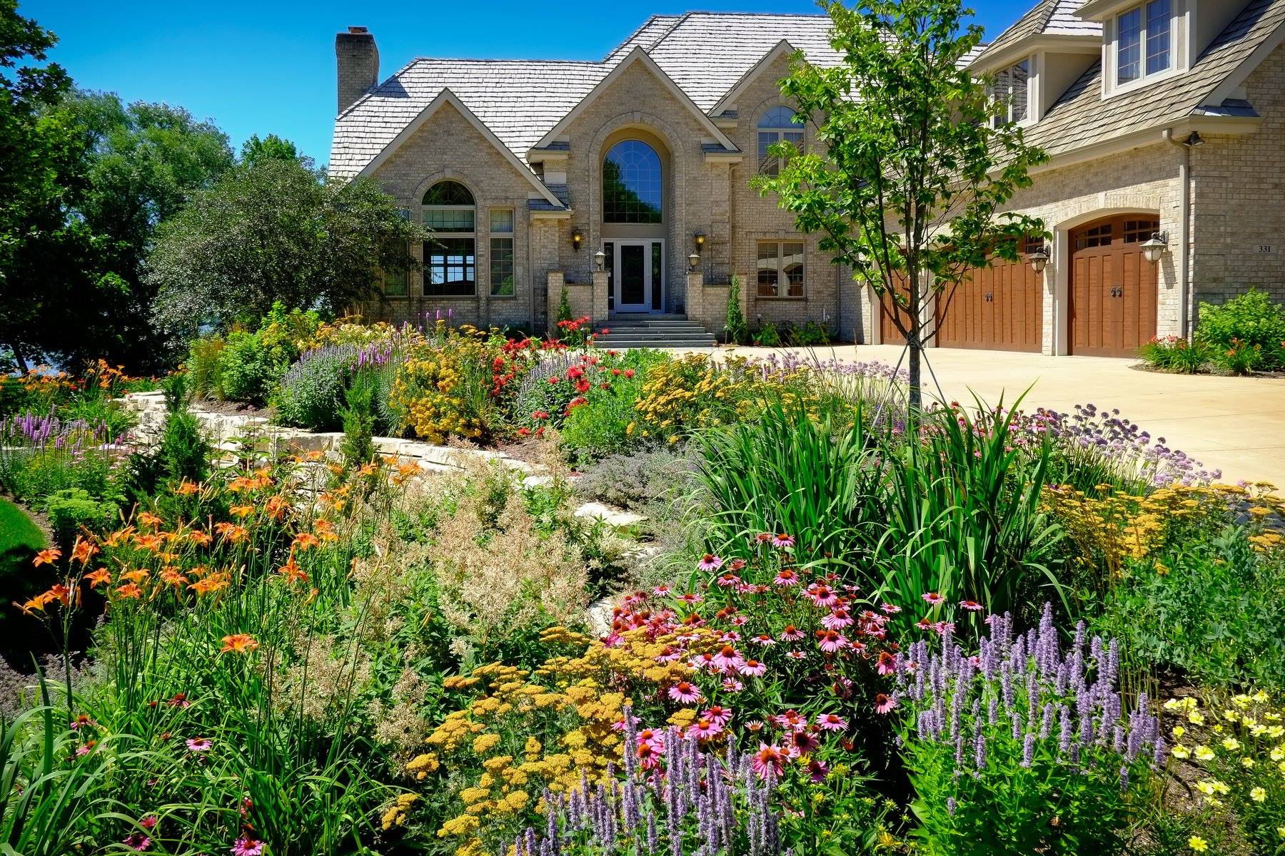 A large house with a lot of flowers in front of it